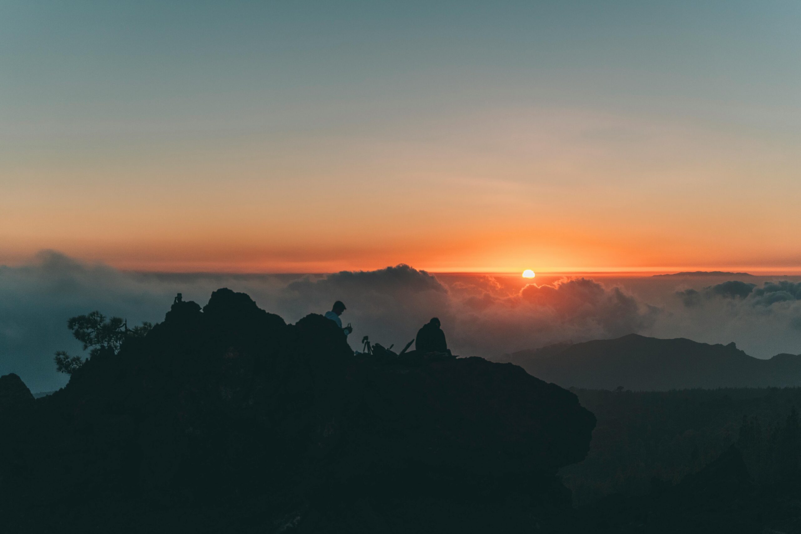 Silhouettes on a mountain during a dramatic sunset at Teide National Park, Spain.